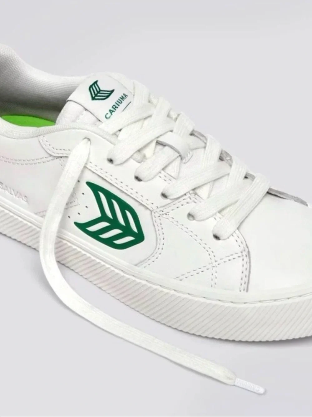 Cariuma White Low-Top Sneakers with Green Leaf Emblem